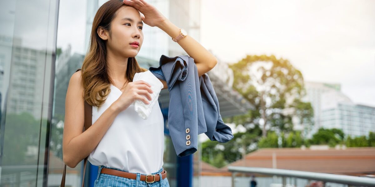 Asian beautiful business woman drying sweat her face